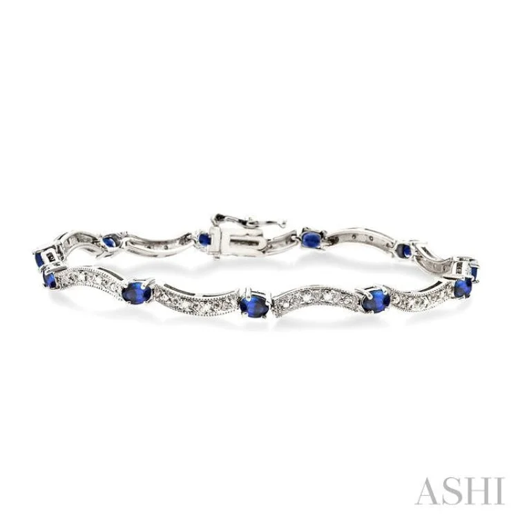 Silver cuff bracelets for women -4x3 MM Oval Cut Sapphire and 1/10 Ctw Single Cut Diamond Bracelet in 14K White Gold